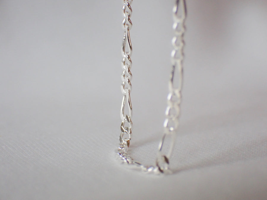 Silver Figaro Chain on white background